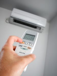 ductless-mini-split-being-turned-on-with-remote